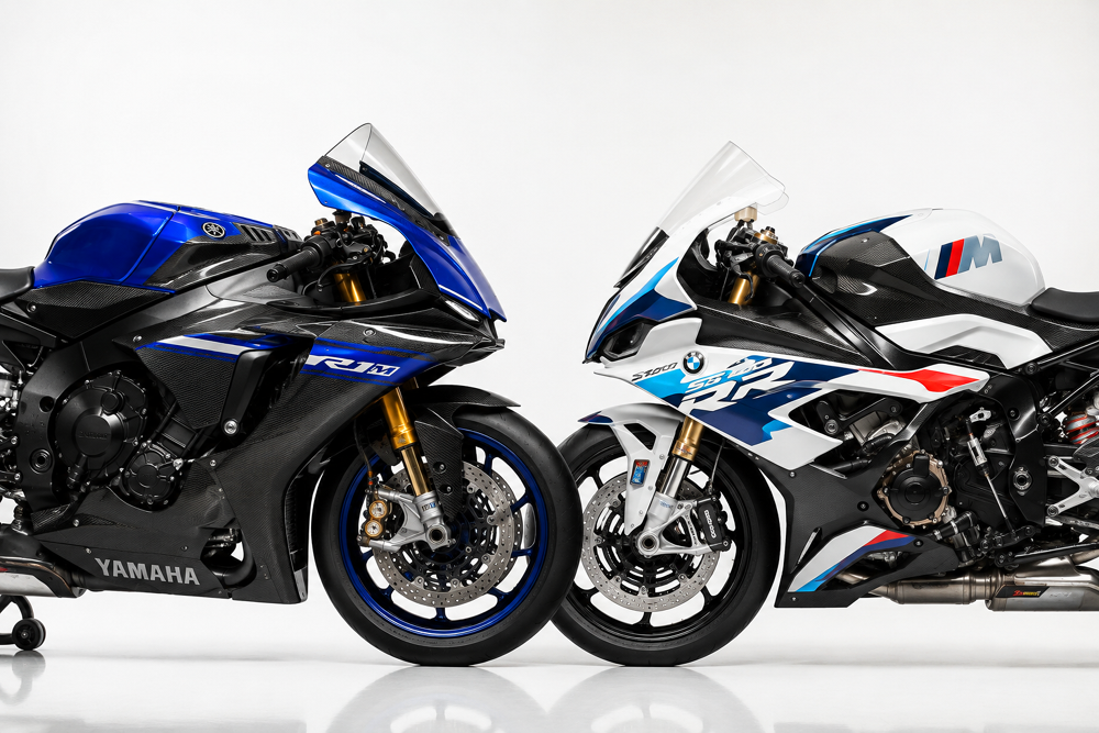 Side-by-side studio photograph of a Yamaha YZF-R1M in blue/carbon livery and a BMW S1000RR in white/blue M livery, both parked nose-to-nose, clean white studio background, professional automotive photography lighting